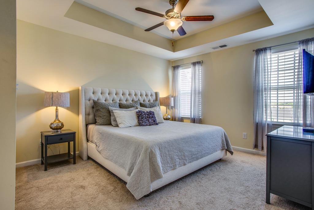 2046 Hemlock Drive Spring Hill, TN 37174 - Photo 15 of 28 a bedroom with a bed and a chandelier