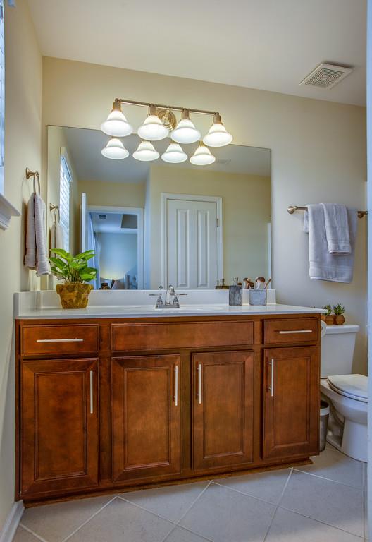 2046 Hemlock Drive Spring Hill, TN 37174 - Photo 18 of 28 a spacious bathroom with a granite countertop sink and a mirror