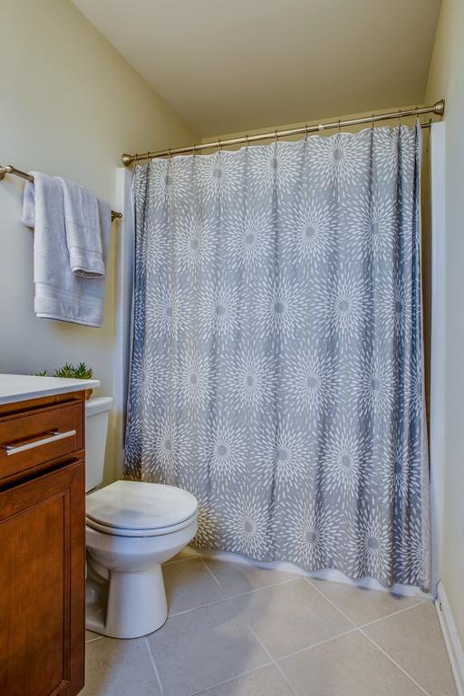 2046 Hemlock Drive Spring Hill, TN 37174 - Photo 19 of 28 a white toilet sitting next to a shower curtain