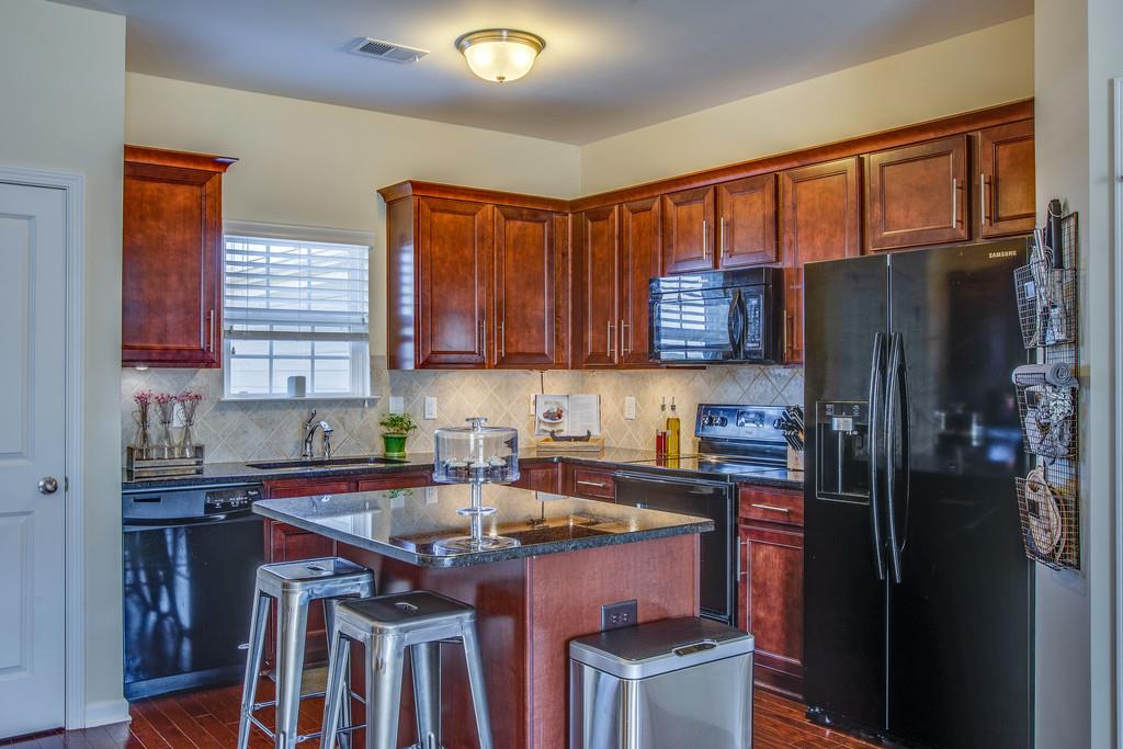 2046 Hemlock Drive Spring Hill, TN 37174 - Photo 7 of 28 a kitchen with stainless steel appliances granite countertop a refrigerator stove top oven a sink and dishwasher