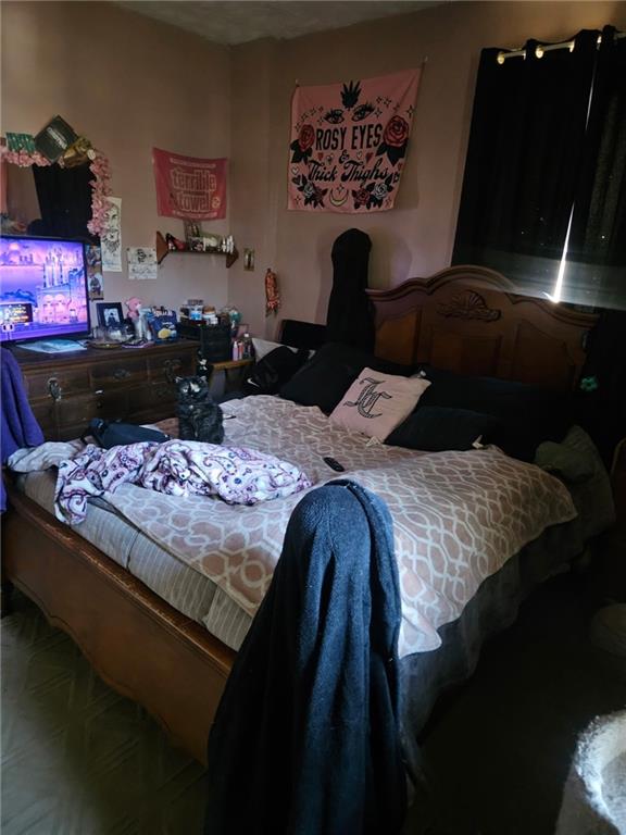 143 Whitestown Road Lyndora, PA 16045 - Photo 15 of 18 a bed sitting in a bedroom next to a wall painting on the wall and a potted plant