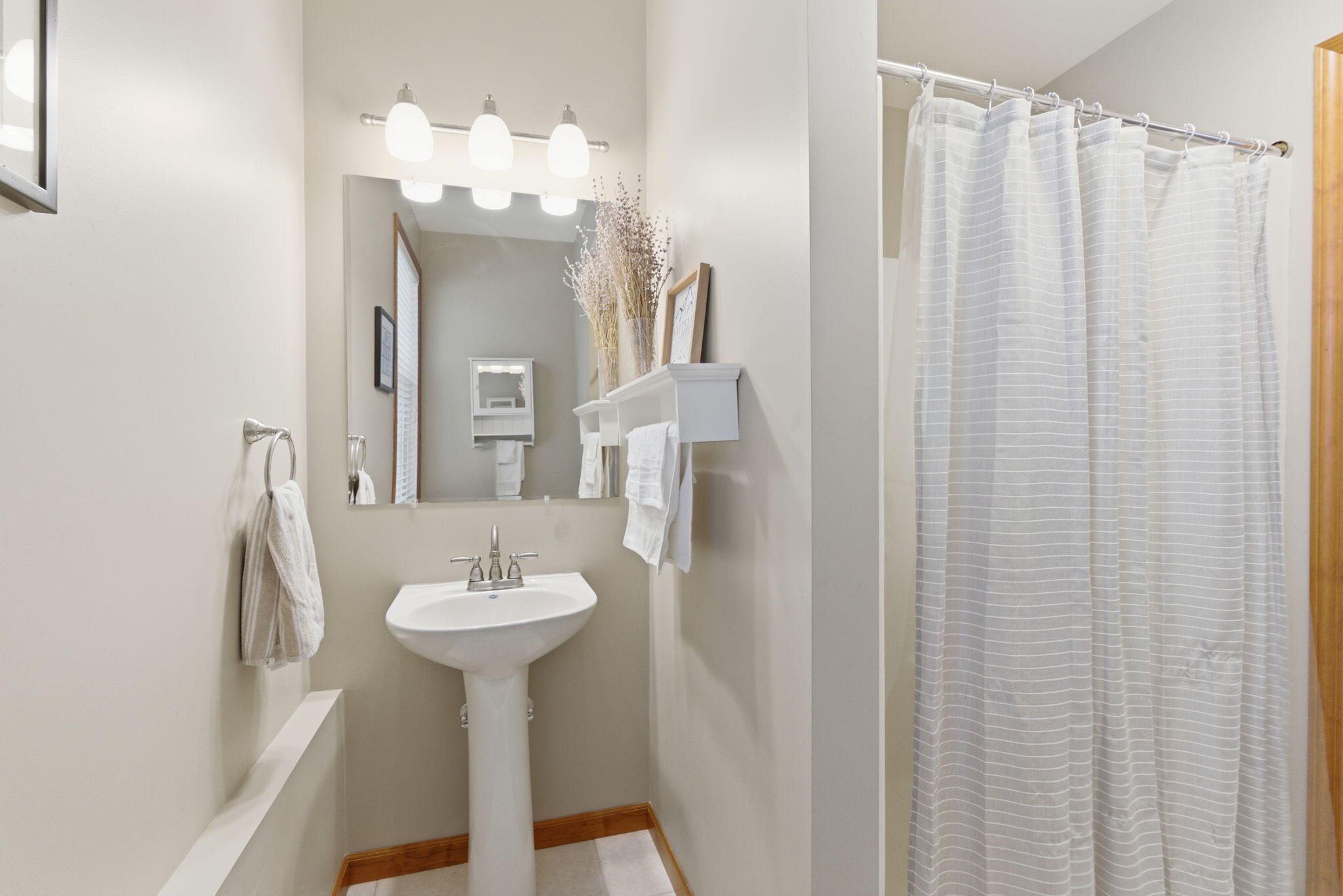 2726 North Goldring Road La Porte, IN 46350 - Photo 23 of 34 a bathroom with a sink a mirror and a shower curtain