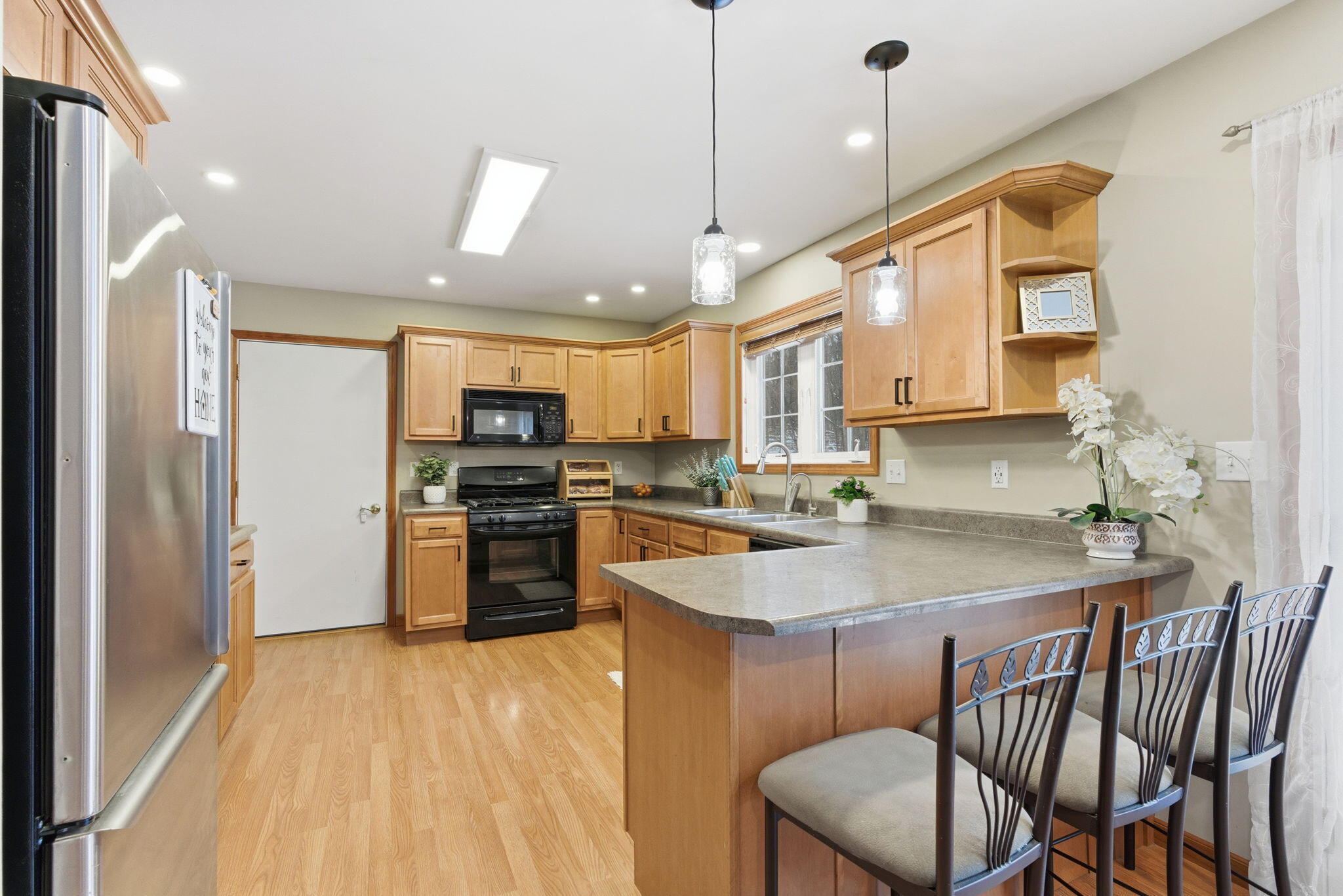 2726 North Goldring Road La Porte, IN 46350 - Photo 7 of 34 a kitchen with a table chairs sink and cabinets