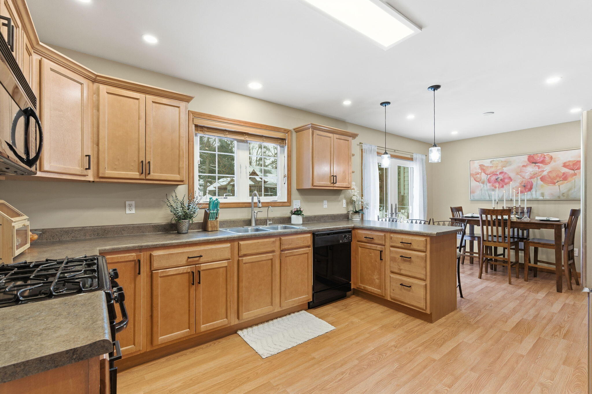 2726 North Goldring Road La Porte, IN 46350 - Photo 8 of 34 a kitchen with stainless steel appliances granite countertop a stove top oven a sink dishwasher and white cabinets with wooden floor