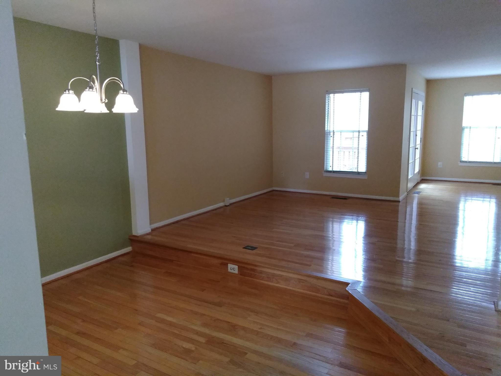 1384 Park Garden Lane Reston, VA 20194 - Photo 8 of 17 an empty room with wooden floor and windows