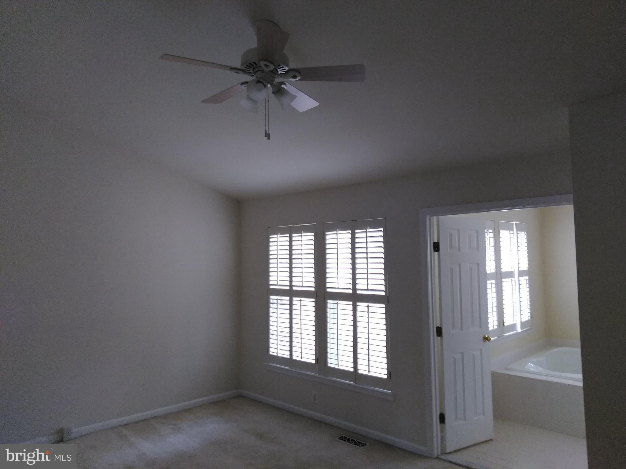 1384 Park Garden Lane Reston, VA 20194 - Photo 10 of 17 an empty room with a window and a ceiling fan