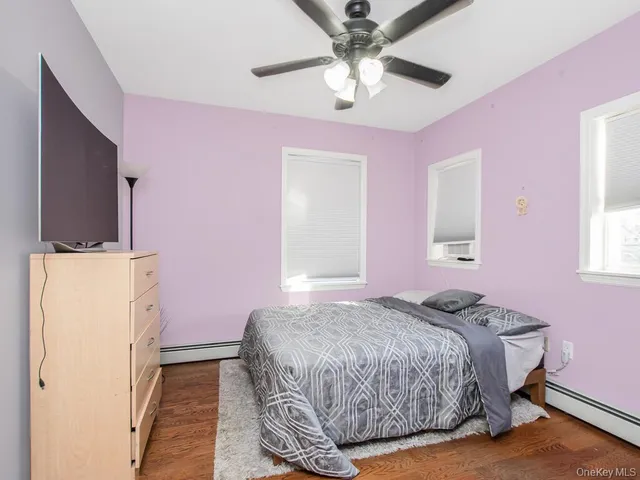 a bedroom with a bed dresser and a window