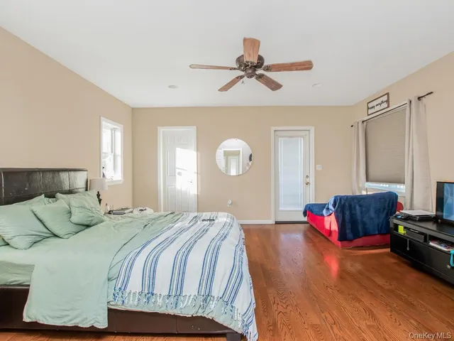 a bedroom with a bed couch and window