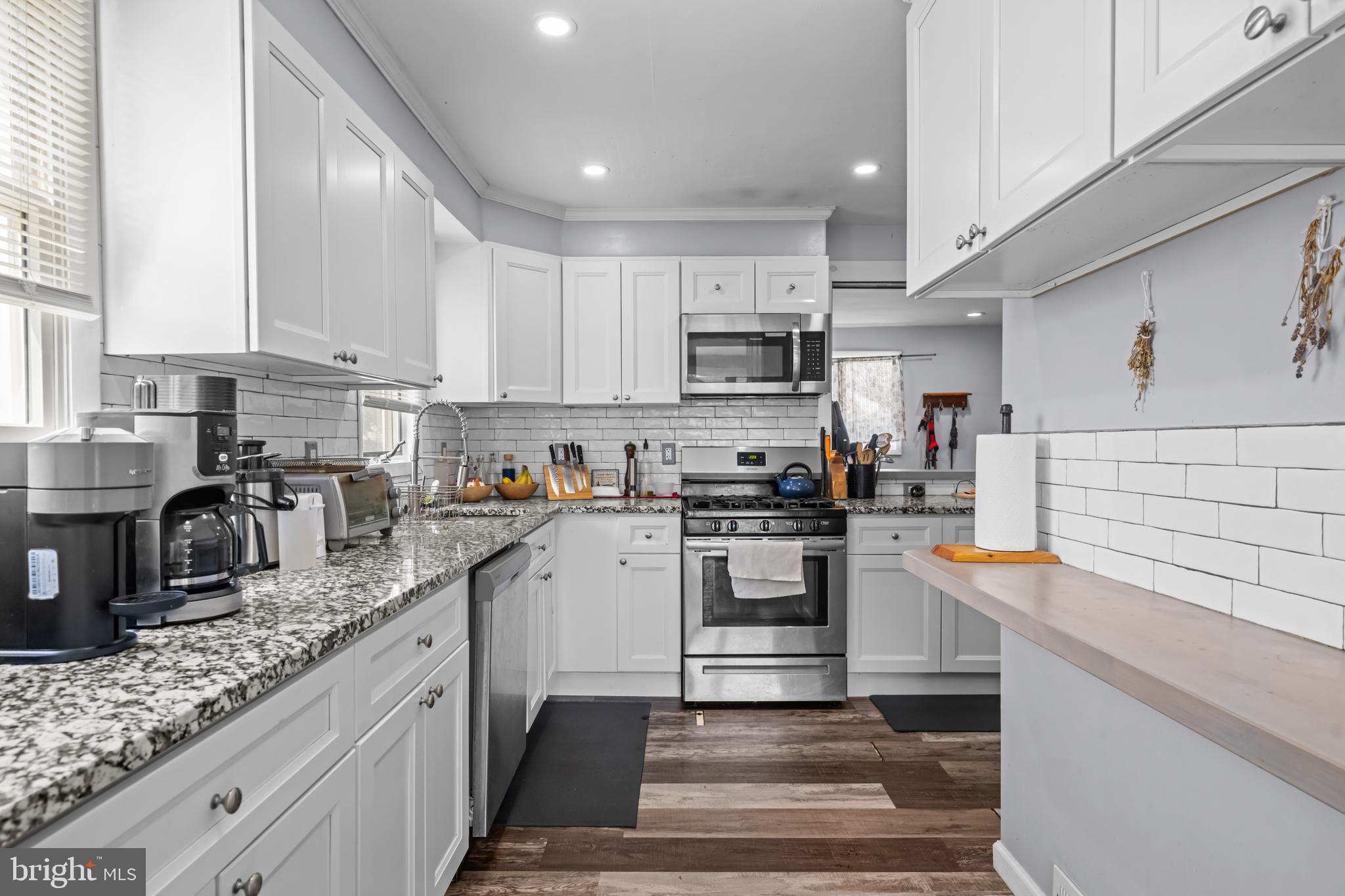 205 Nicholson Road Mount Ephraim, NJ 08059 - Photo 12 of 24 a kitchen with kitchen island granite countertop a sink stove and cabinets