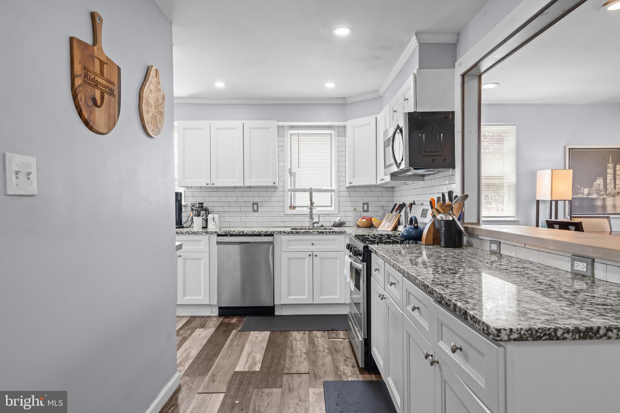 205 Nicholson Road Mount Ephraim, NJ 08059 - Photo 10 of 24 a kitchen with granite countertop a sink and a stove top oven