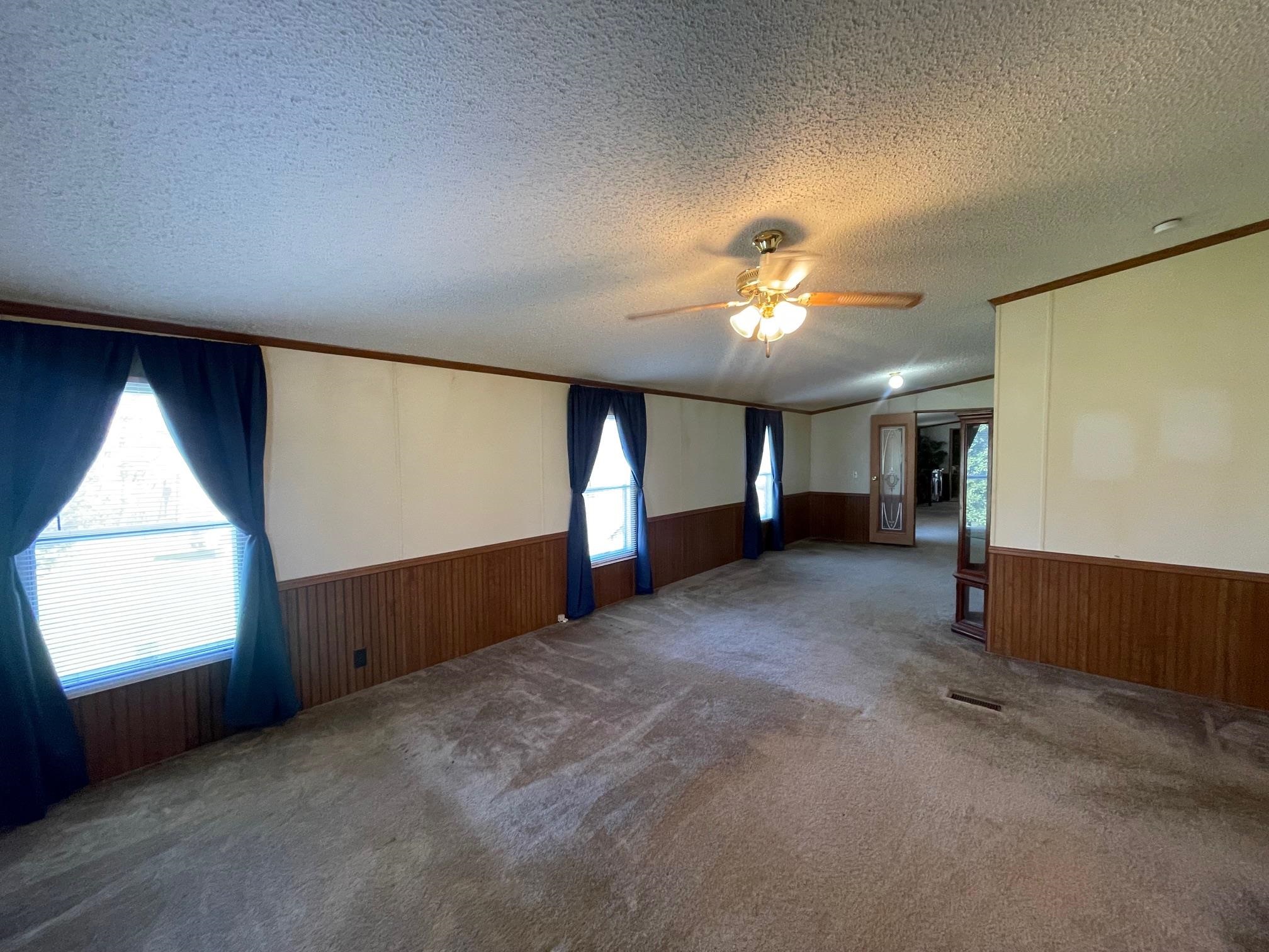 9597 Deadfall Road Brighton, TN 38011 - Photo 13 of 22 a view of a livingroom with a ceiling fan and window