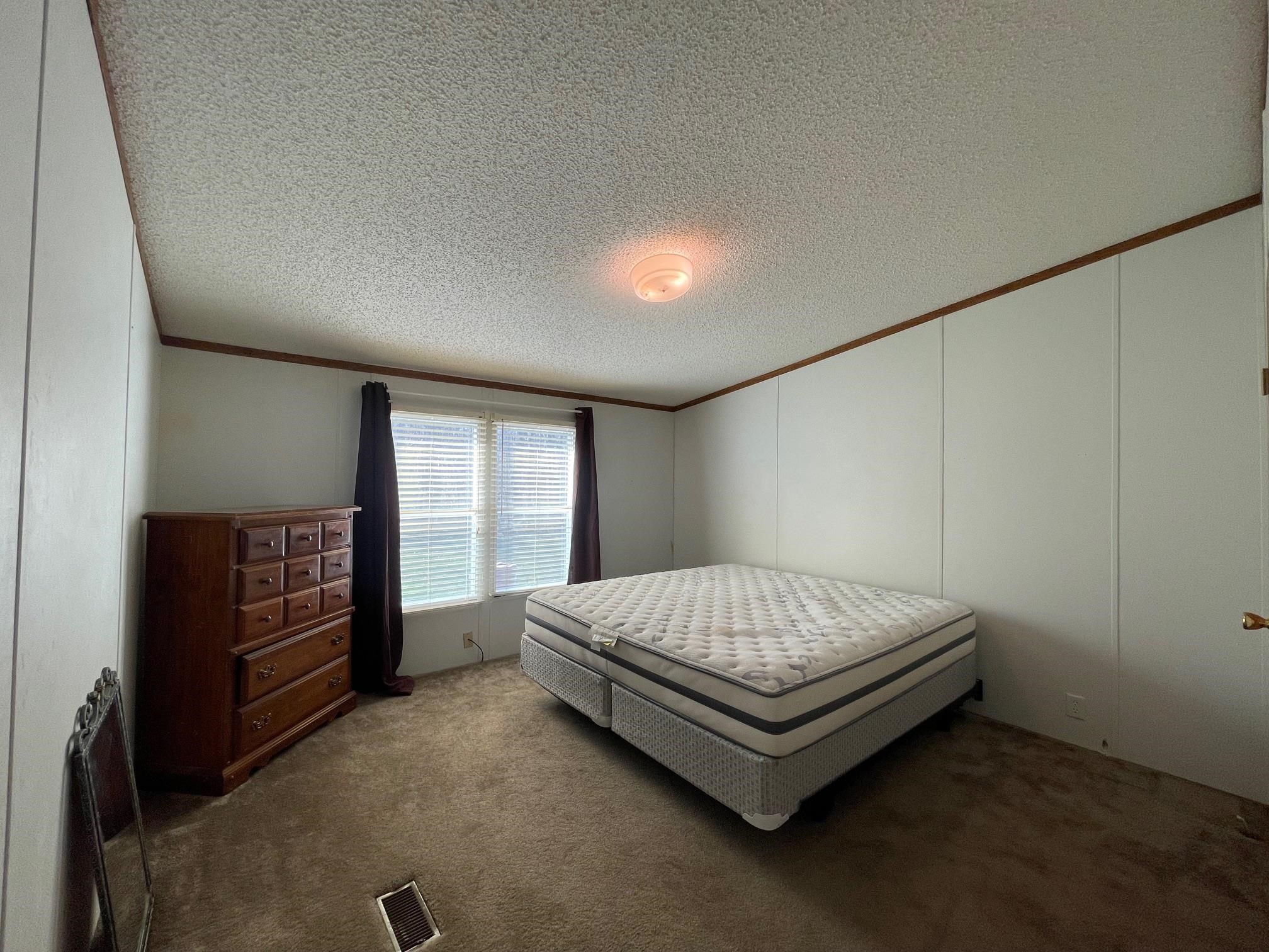 9597 Deadfall Road Brighton, TN 38011 - Photo 17 of 22 a bed sitting in a room next to a window
