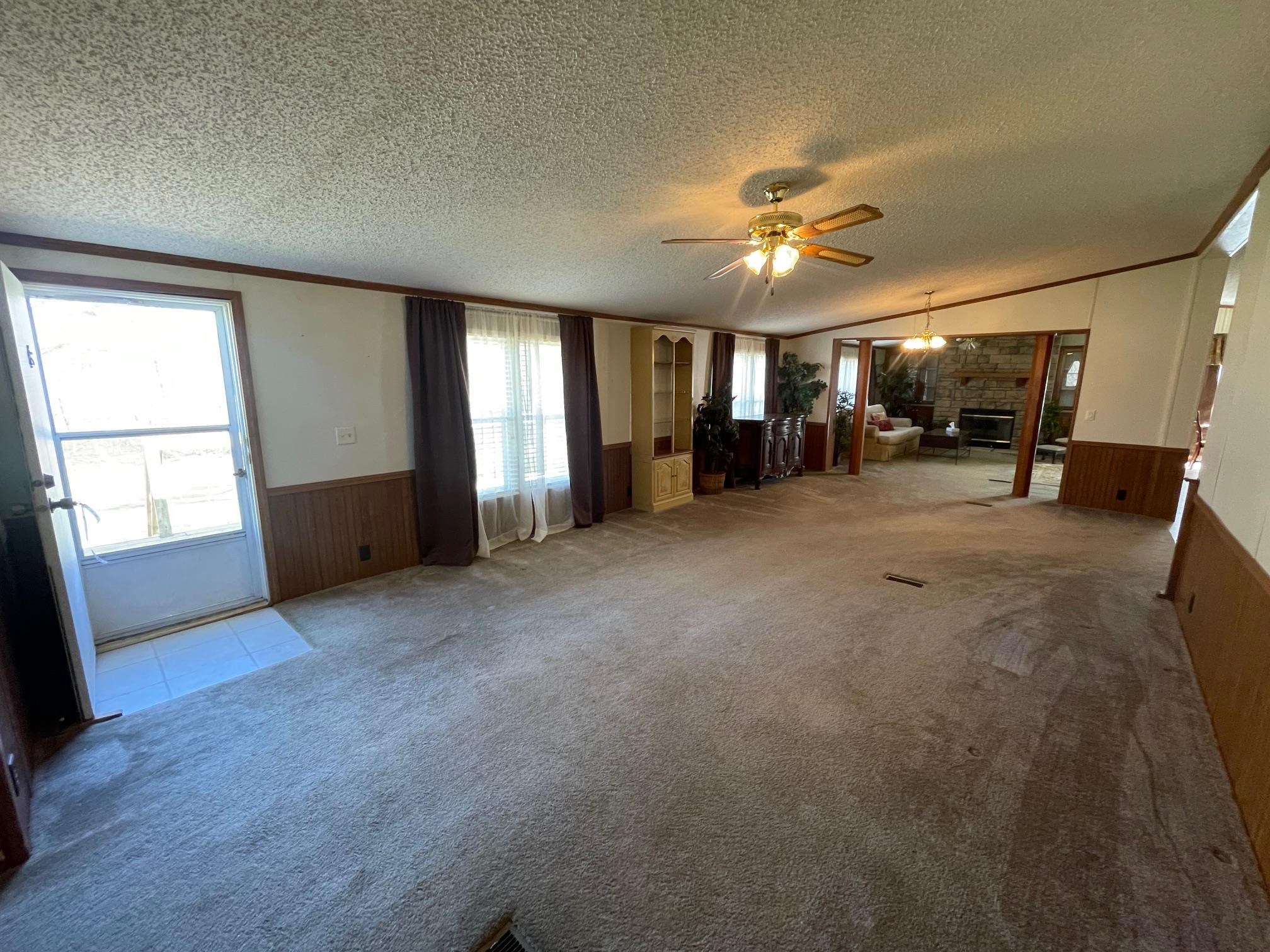 9597 Deadfall Road Brighton, TN 38011 - Photo 5 of 22 a view of a livingroom with furniture and a ceiling fan