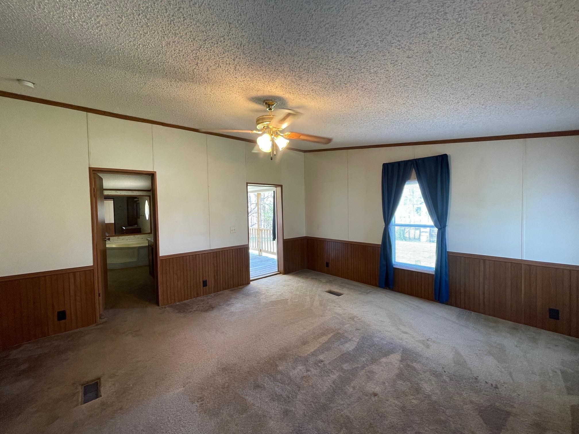 9597 Deadfall Road Brighton, TN 38011 - Photo 6 of 22 an empty room with windows and fireplace