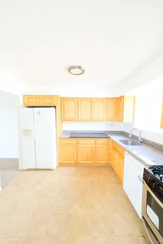 a view of a kitchen with a sink and a window