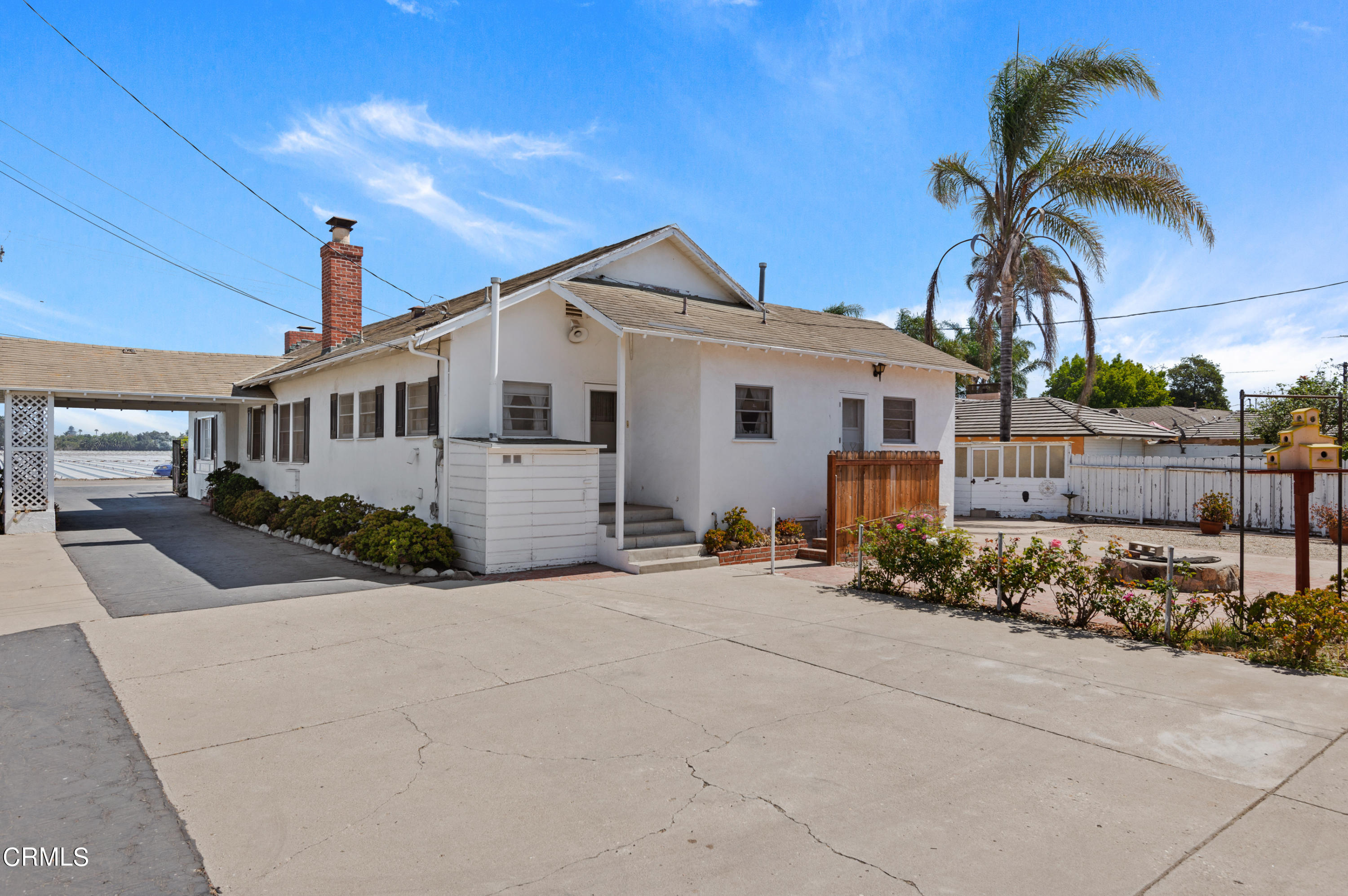 1602 Teal Club Road Oxnard, CA 93030 - Photo 20 of 30 a front view of a house with a garden