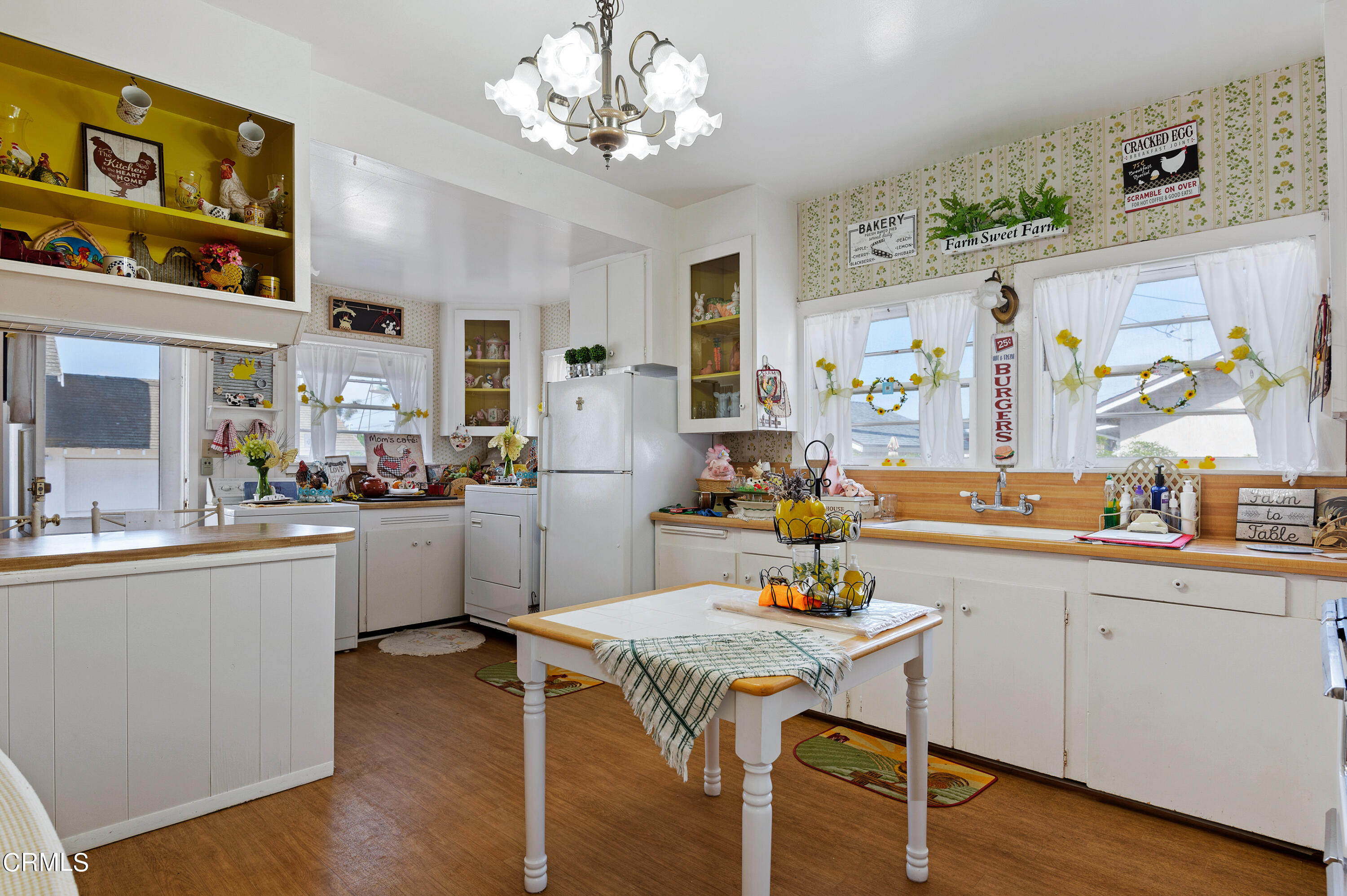 1602 Teal Club Road Oxnard, CA 93030 - Photo 10 of 30 a kitchen with a table chairs stove and cabinets