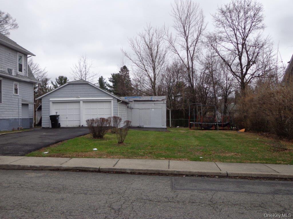 208 Saddle River Road Monsey, NY 10952 - Photo 2 of 4 a front view of a house with a yard and garage