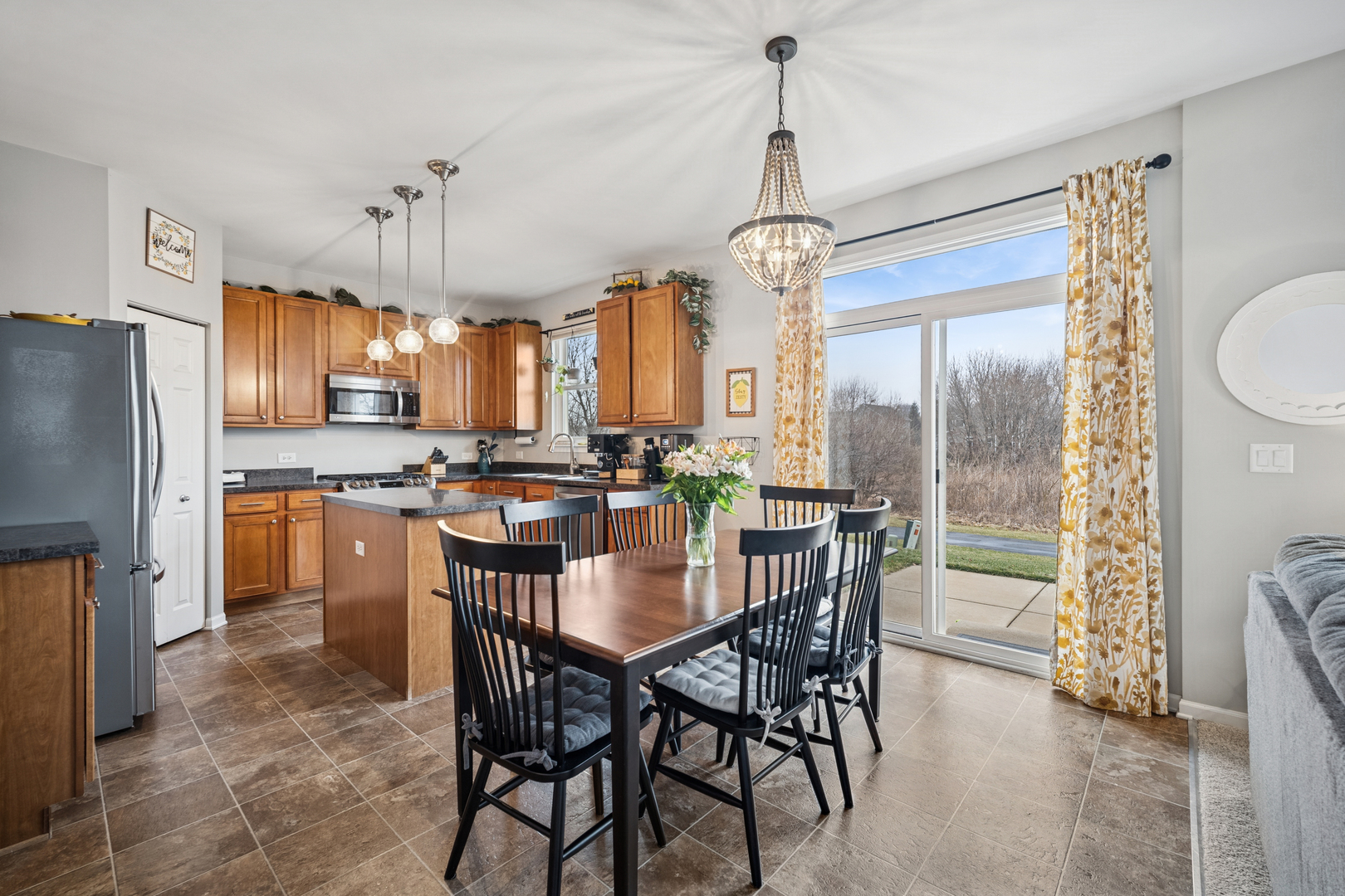 359 Copper Springs Lane Elgin, IL 60124 - Photo 4 of 23 a kitchen with refrigerator a sink and chairs
