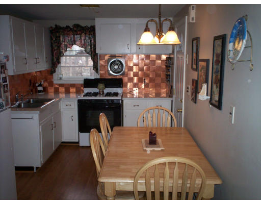 20 Elizabeth Road Billerica, MA 01821 - Photo 5 of 11 a kitchen with a table chairs stove and microwave