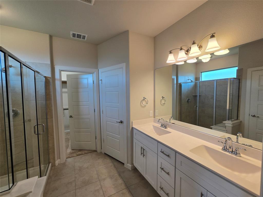 508 Williams Way Van Alstyne, TX 75495 - Photo 11 of 26 a bathroom with a double vanity sink shower and a mirror