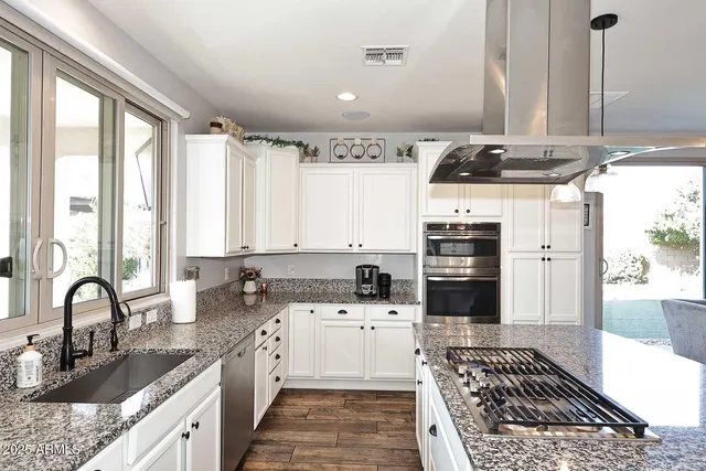a kitchen with a stove a sink and a refrigerator