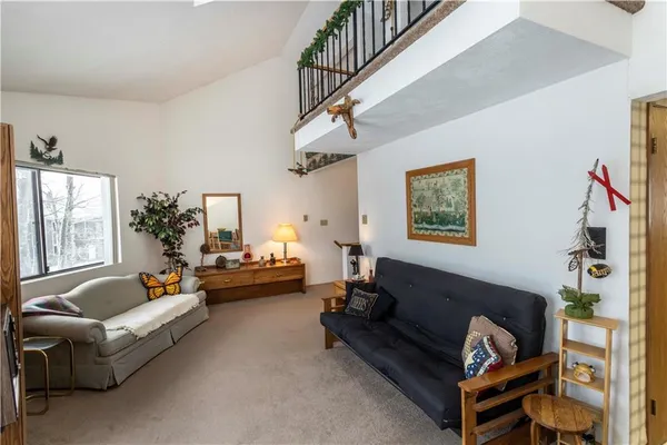 a living room with furniture ceiling fan and a window