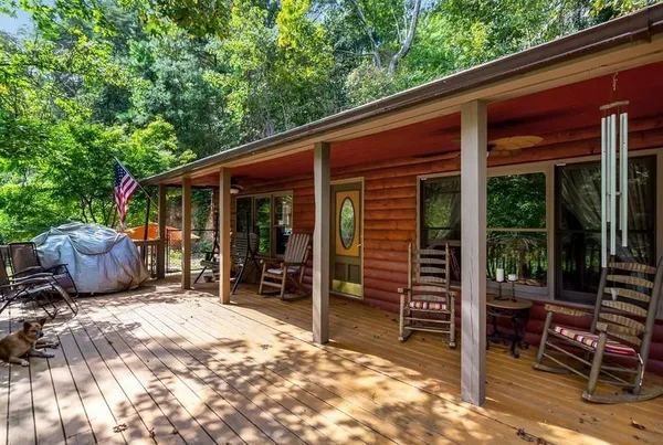 a view of a patio with table and chairs and wooden fence