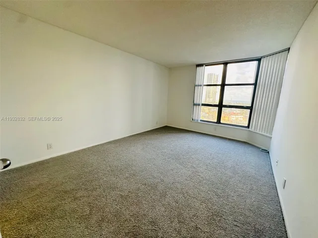 a view of a livingroom with an empty space and a sink