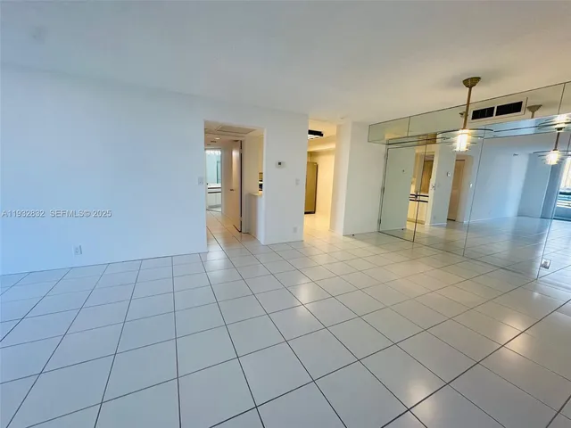 a kitchen with stainless steel appliances granite countertop a sink a stove a microwave and a refrigerator