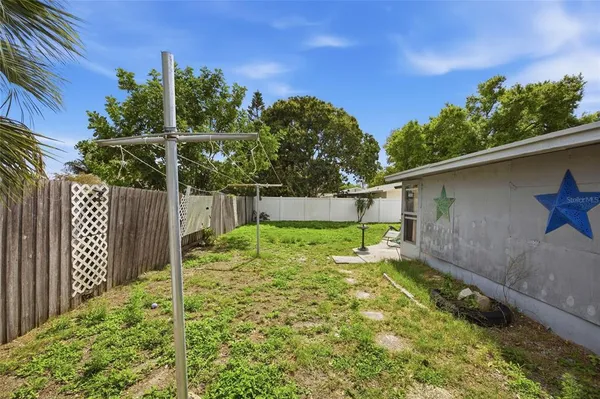 a backyard of a house with plants and trees
