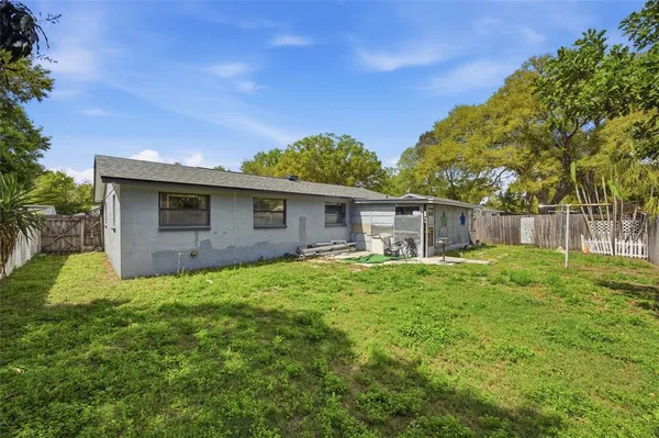 a backyard of a house with plants and tree