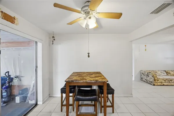 a dining room with furniture and chandelier
