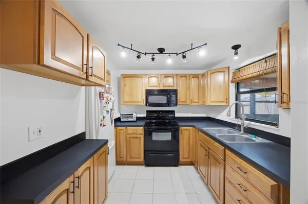 a kitchen with stainless steel appliances granite countertop a sink and stove