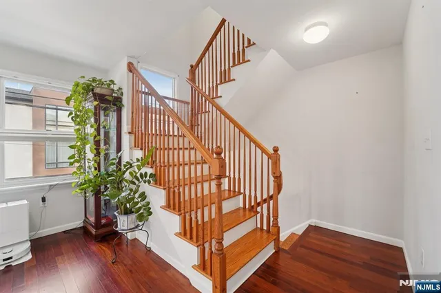 a view of staircase with railing and white walls