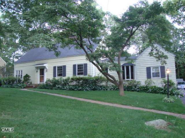 69 Stoneleigh Road Fairfield, CT 06825 - Photo 1 of 1 a front view of a house with a garden and yard