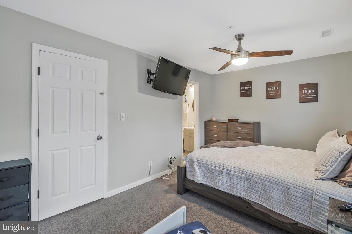 13111 Ripon Place Upper Marlboro, MD 20772 - Photo 18 of 32 a bedroom with a bed and a flat screen tv