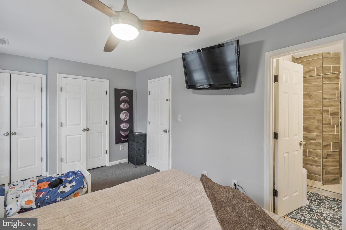 13111 Ripon Place Upper Marlboro, MD 20772 - Photo 19 of 32 a bedroom with a bed and a flat screen tv