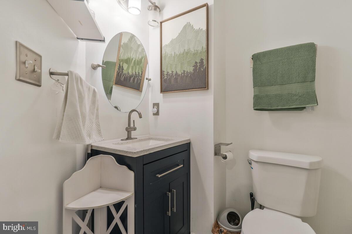 13111 Ripon Place Upper Marlboro, MD 20772 - Photo 21 of 32 a bathroom with a toilet sink and mirror