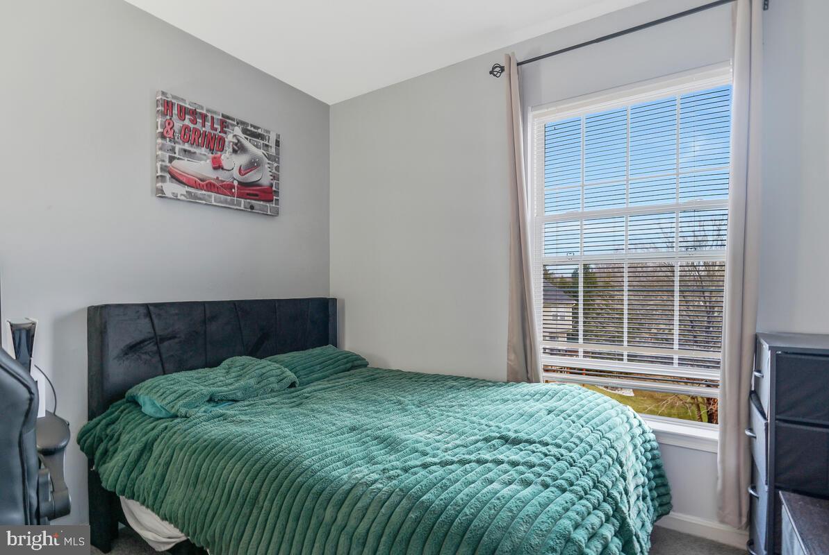 13111 Ripon Place Upper Marlboro, MD 20772 - Photo 23 of 32 a bed sitting in a bedroom next to a window