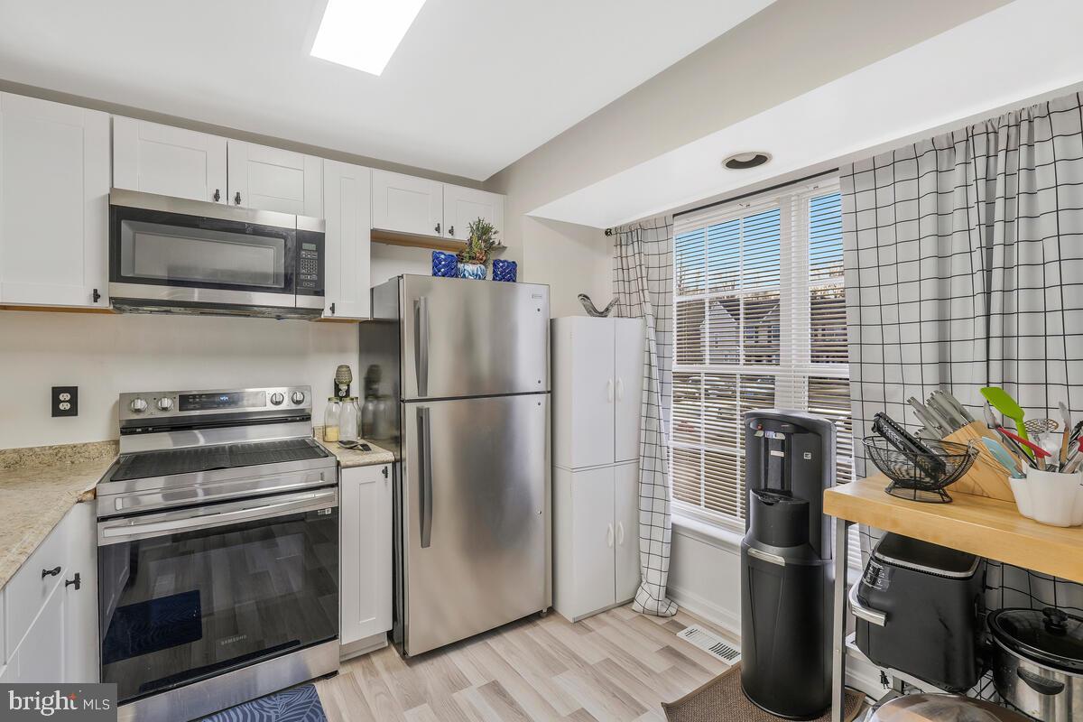 13111 Ripon Place Upper Marlboro, MD 20772 - Photo 5 of 32 a kitchen with a refrigerator stove and microwave