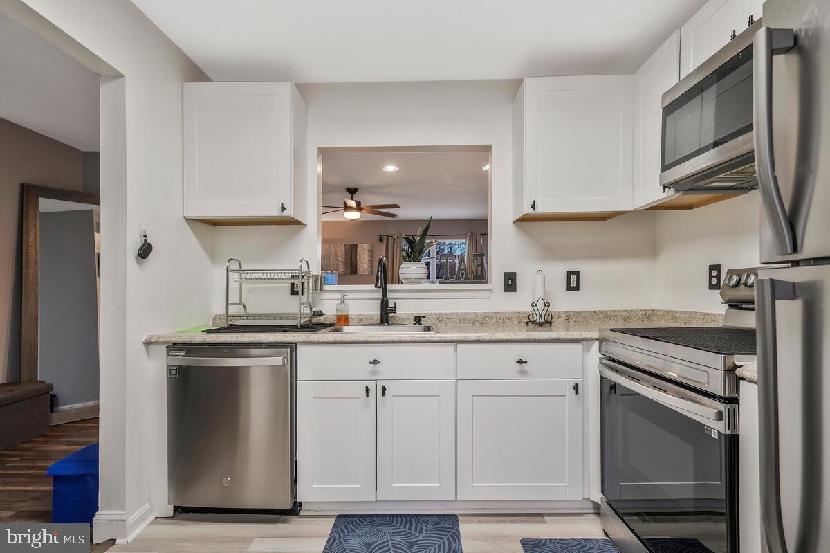 13111 Ripon Place Upper Marlboro, MD 20772 - Photo 8 of 32 a kitchen with a sink stove and cabinets