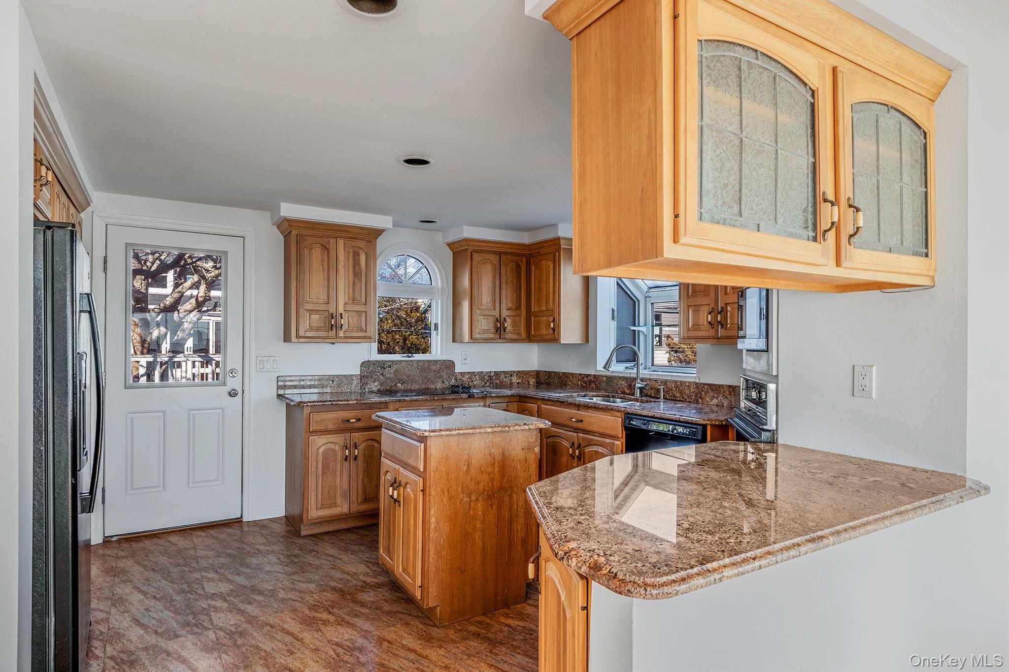 116 Oak Beach Road Babylon, NY 11702 - Photo 12 of 37 a kitchen with stainless steel appliances granite countertop a sink stove and cabinets