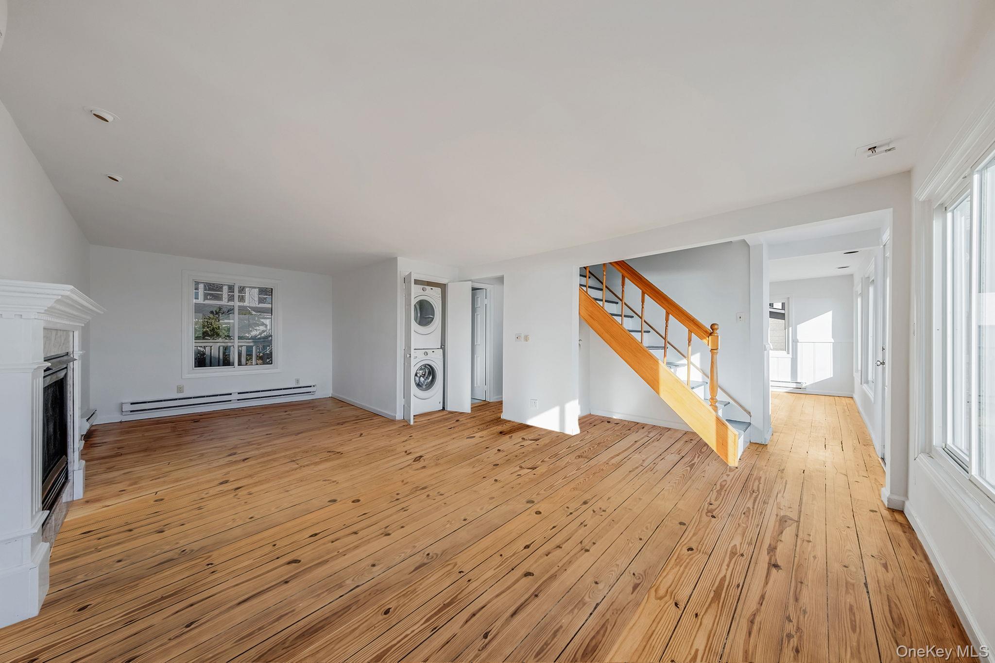 116 Oak Beach Road Babylon, NY 11702 - Photo 13 of 37 a view of empty room with wooden floor and fan
