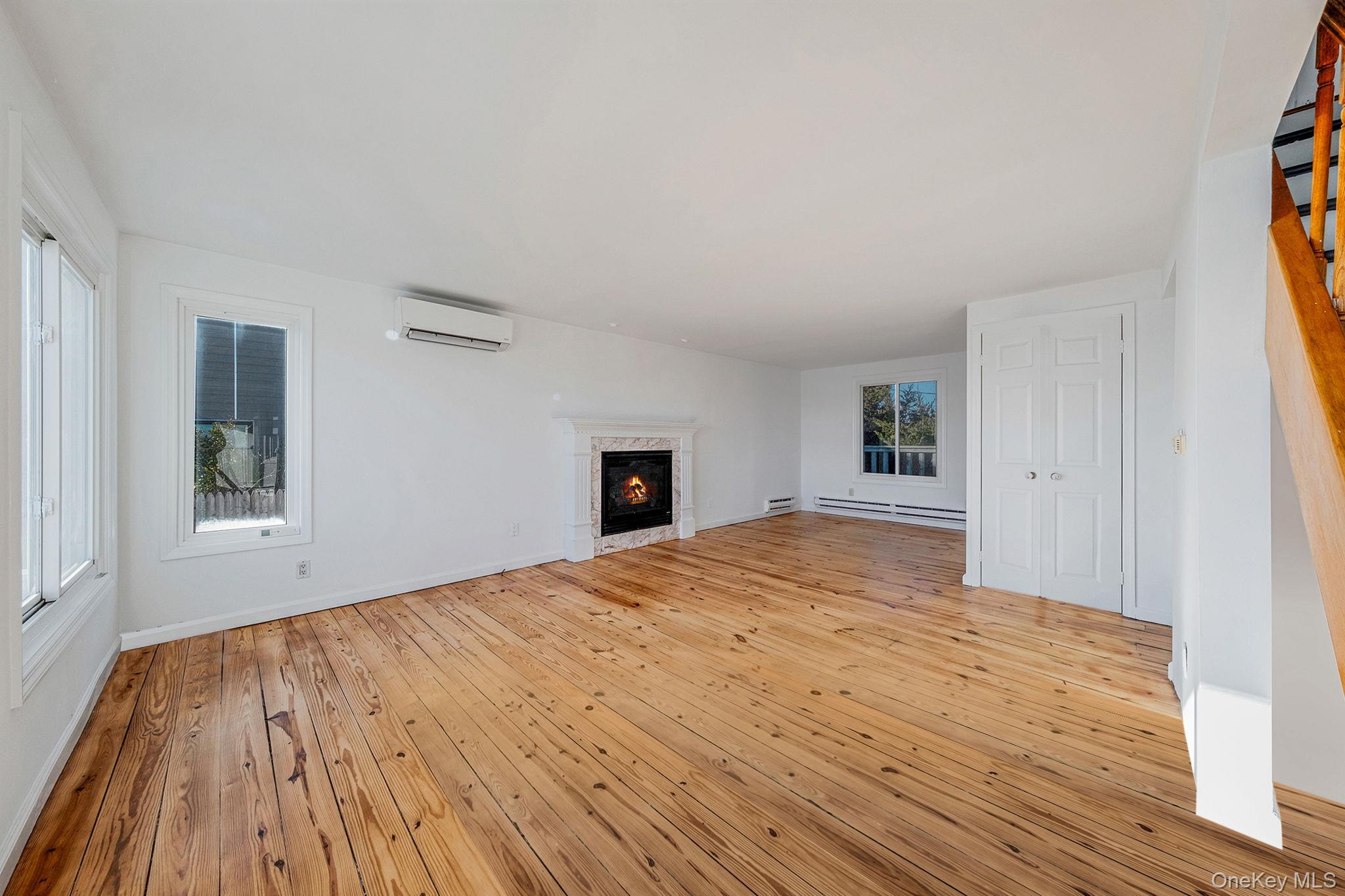116 Oak Beach Road Babylon, NY 11702 - Photo 14 of 37 a big room with wooden floor and windows