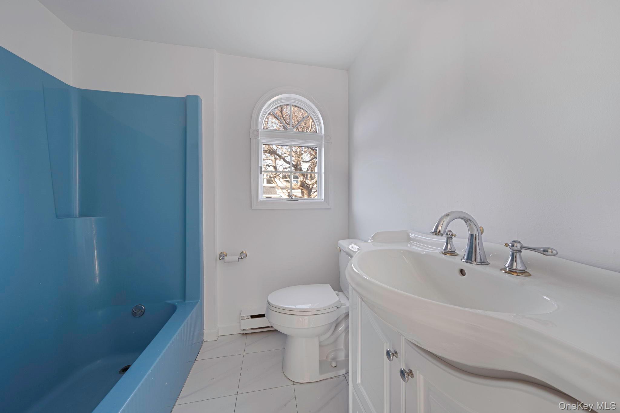 116 Oak Beach Road Babylon, NY 11702 - Photo 18 of 37 a bathroom with a sink a toilet and shower