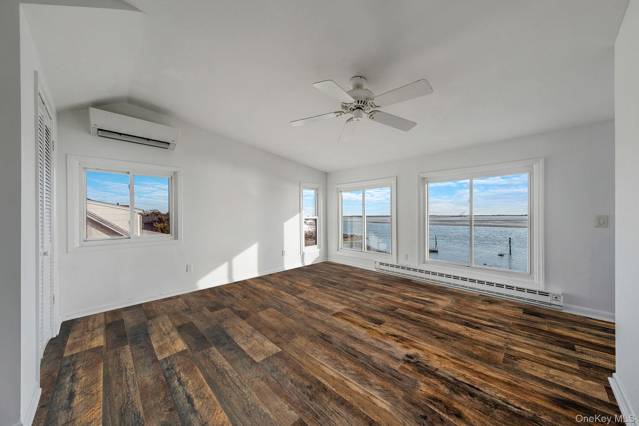 116 Oak Beach Road Babylon, NY 11702 - Photo 21 of 37 a view of empty room with wooden floor and fan