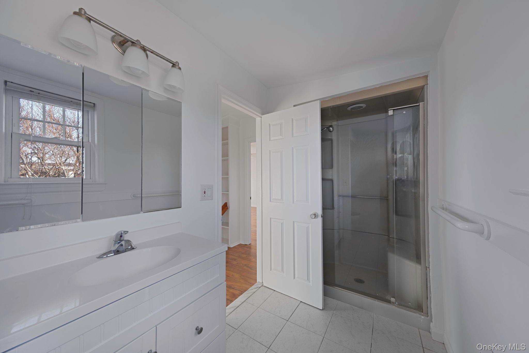 116 Oak Beach Road Babylon, NY 11702 - Photo 23 of 37 a bathroom with a bathtub and a sink