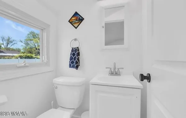 a bathroom with a toilet sink and mirror