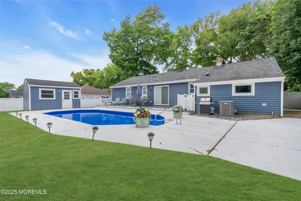 a view of a house with a backyard porch and sitting area